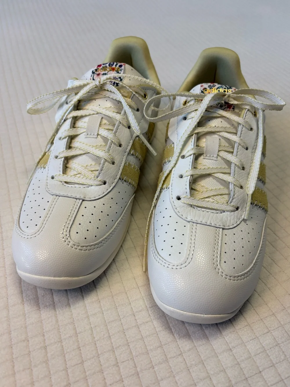 Adidas cream colored sneakers with floral accents